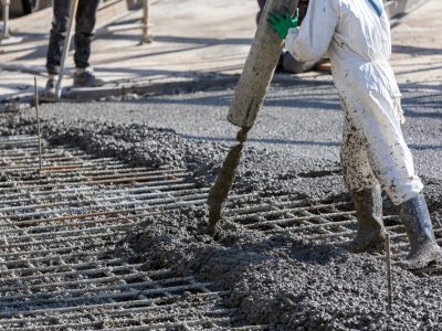 Construction,Worker,Is,Pouring,And,Smoothing,Out,Concrete,With,Ready-mix